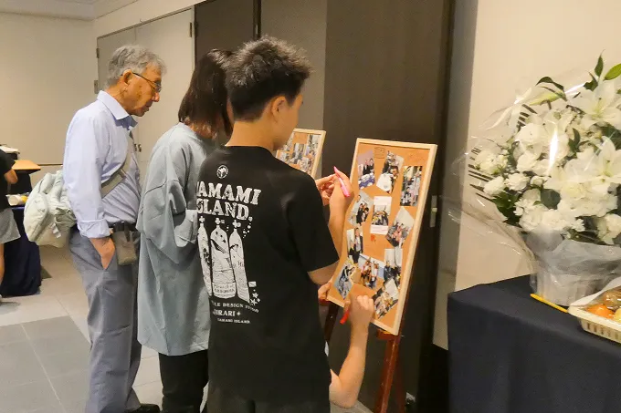 おじいちゃんと写真を眺める孫たち